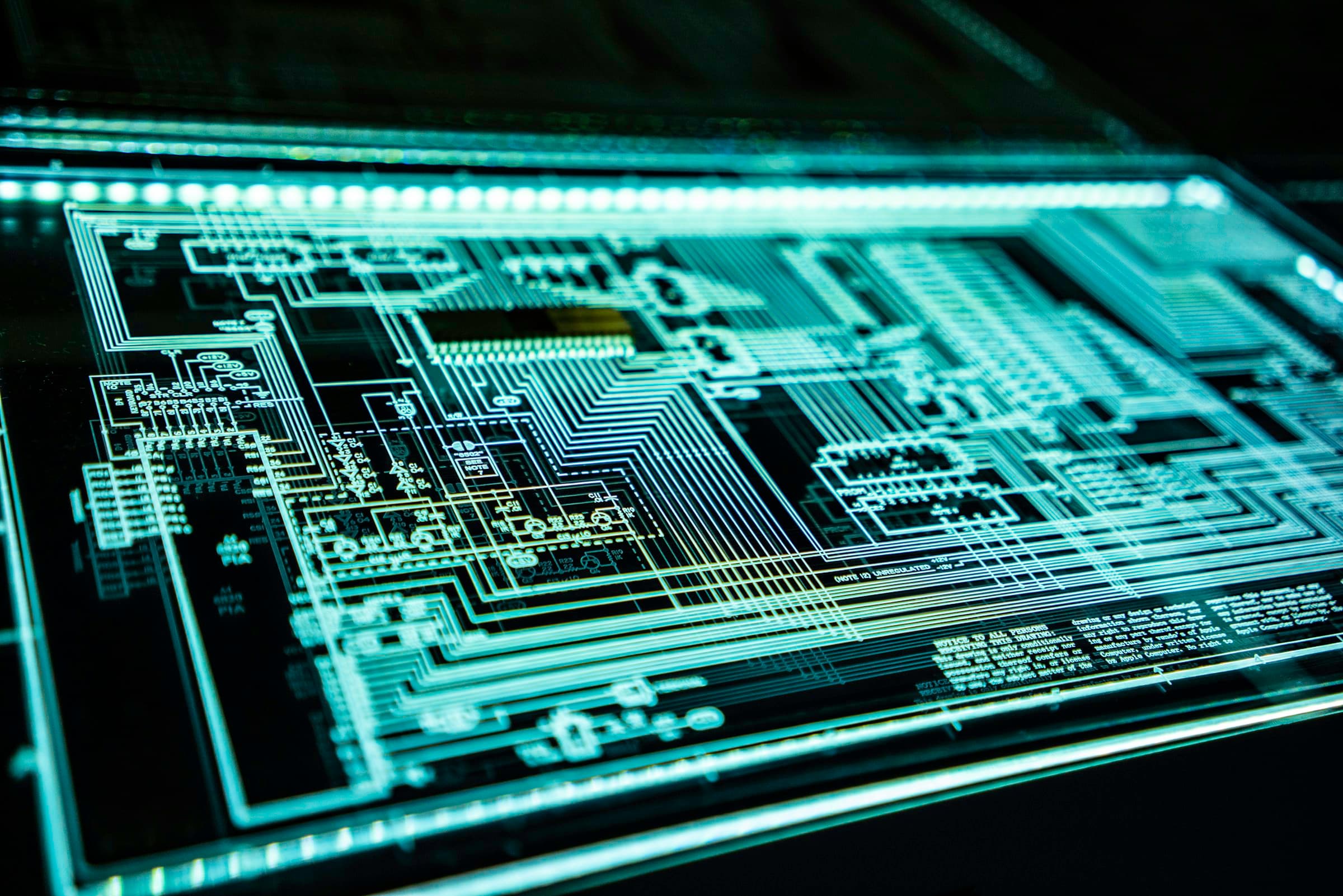 Cyan illuminated circuit schematic representing technical engineering and software architecture